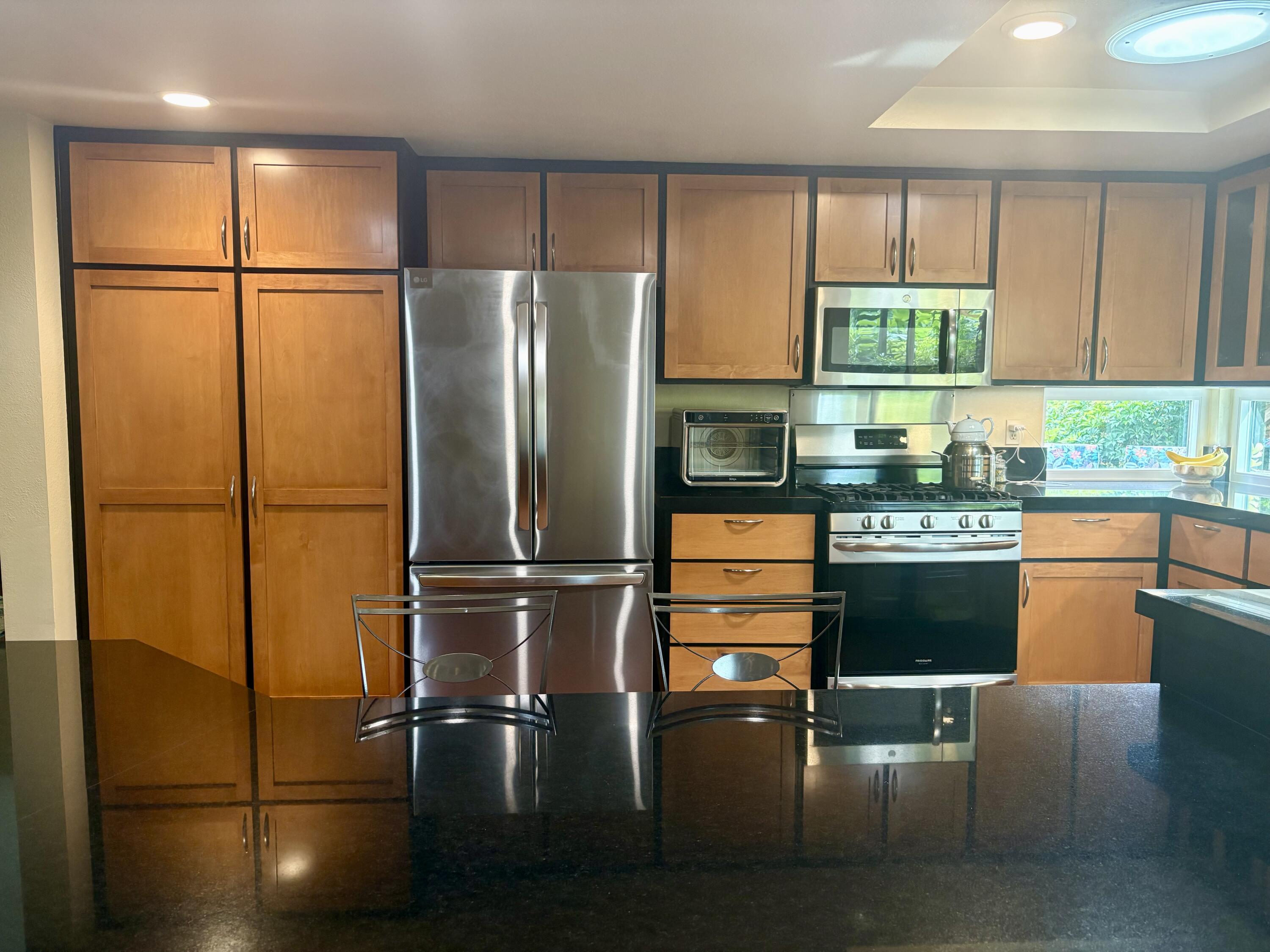 731 Dos Hermanos Road Santa Barbara, CA 93111 - Photo 7 of 27 a kitchen with stainless steel appliances granite countertop a refrigerator sink and cabinets