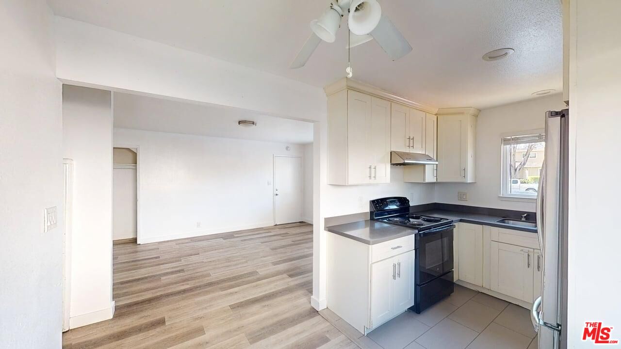 a kitchen with granite countertop a stove and a sink