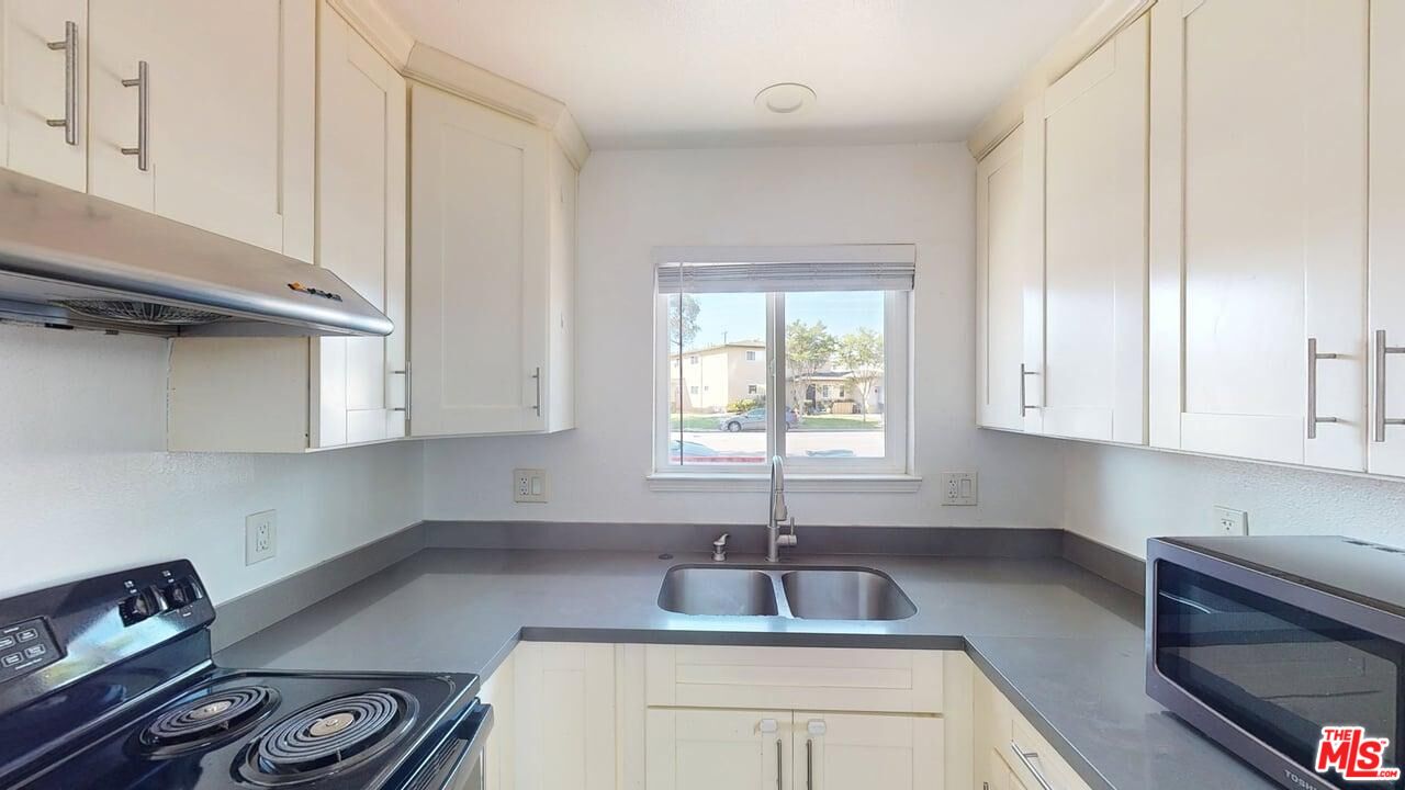 2129 Monroe Street Santa Clara, CA 95050 - Photo 2 of 12 a kitchen with granite countertop a sink stainless steel appliances and cabinets