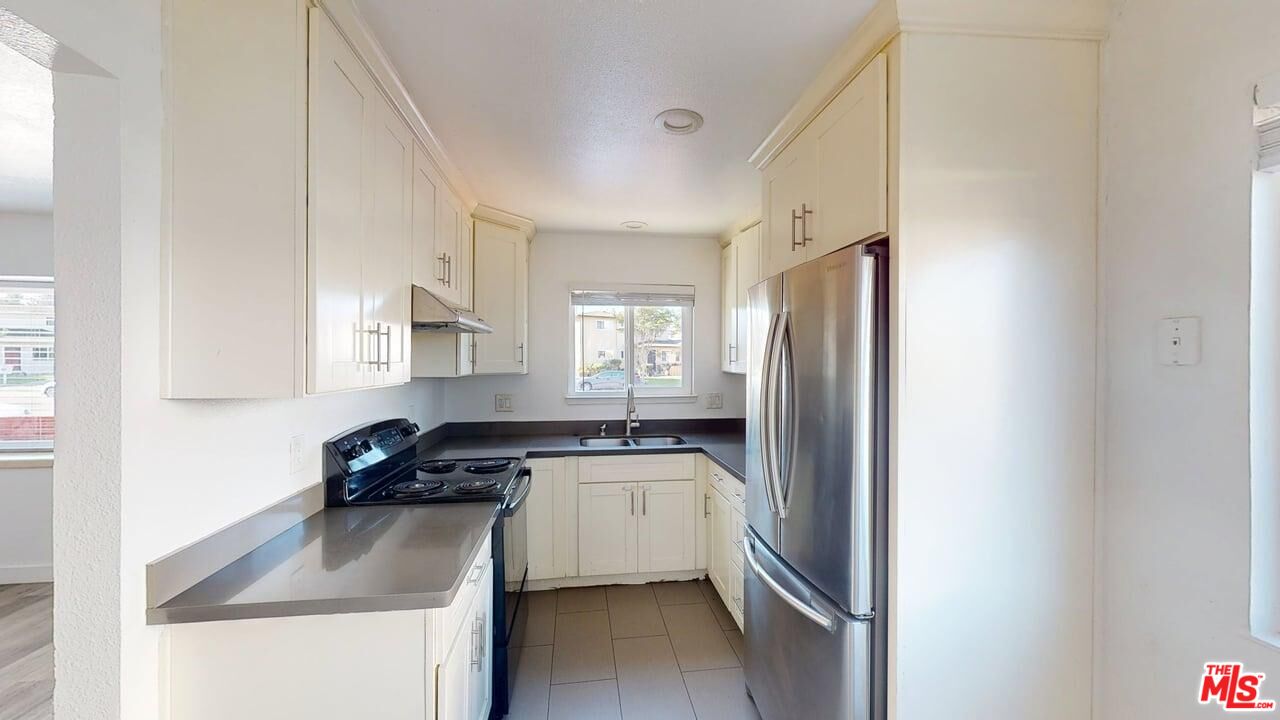 2129 Monroe Street Santa Clara, CA 95050 - Photo 3 of 12 a kitchen with a refrigerator a sink and white cabinets