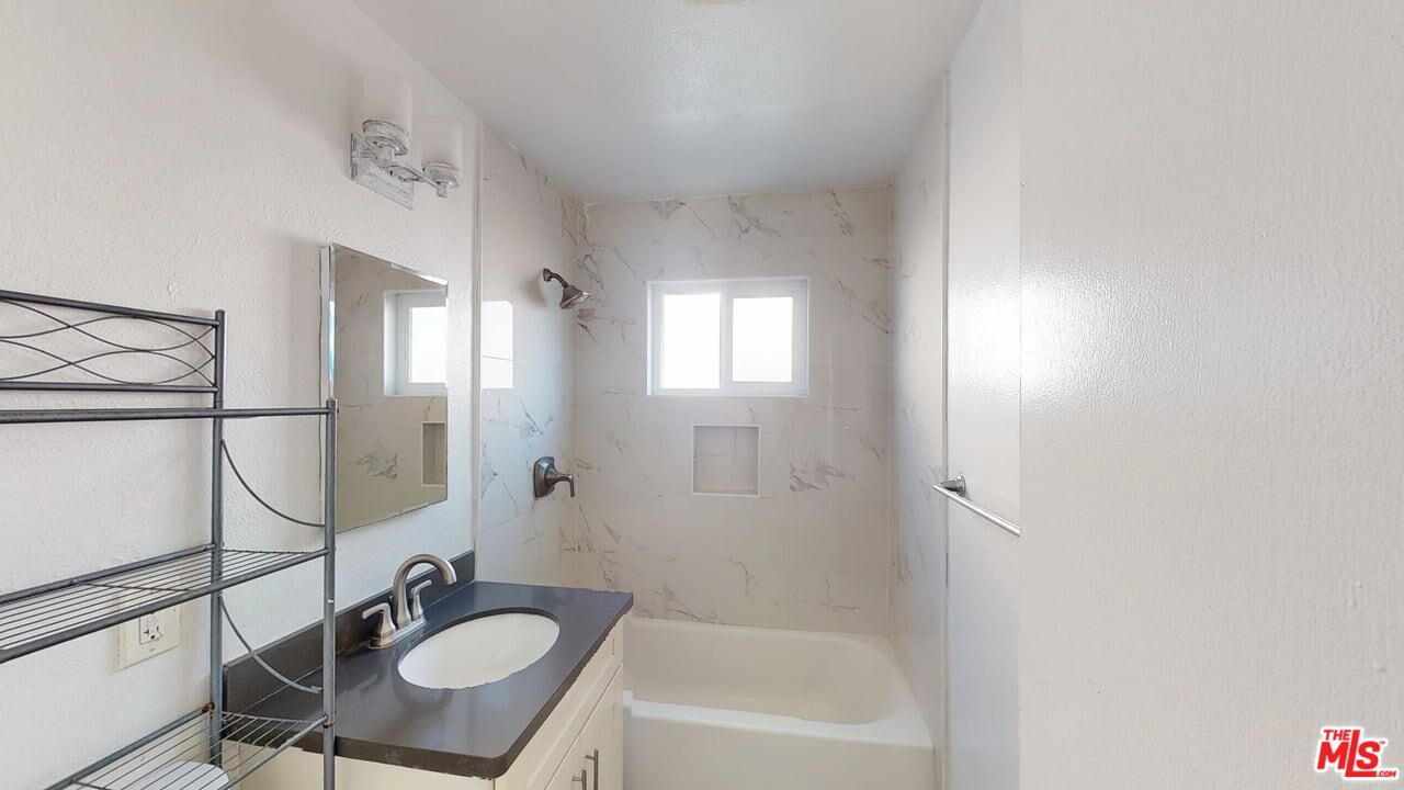 2129 Monroe Street Santa Clara, CA 95050 - Photo 6 of 12 a bathroom with a sink a mirror and a bathtub
