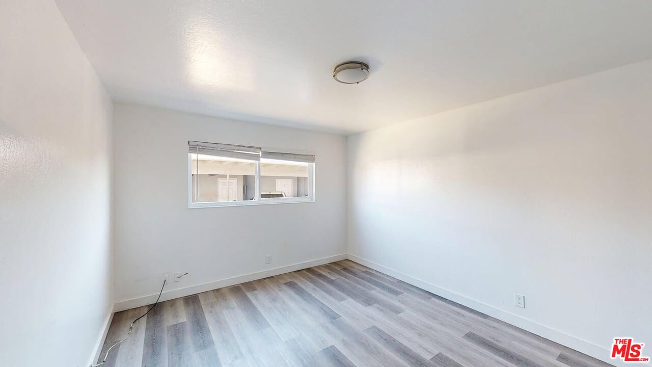 2129 Monroe Street Santa Clara, CA 95050 - Photo 7 of 12 an empty room with wooden floor and windows
