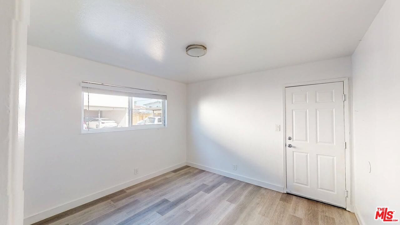 2129 Monroe Street Santa Clara, CA 95050 - Photo 8 of 12 an empty room with wooden floor and windows