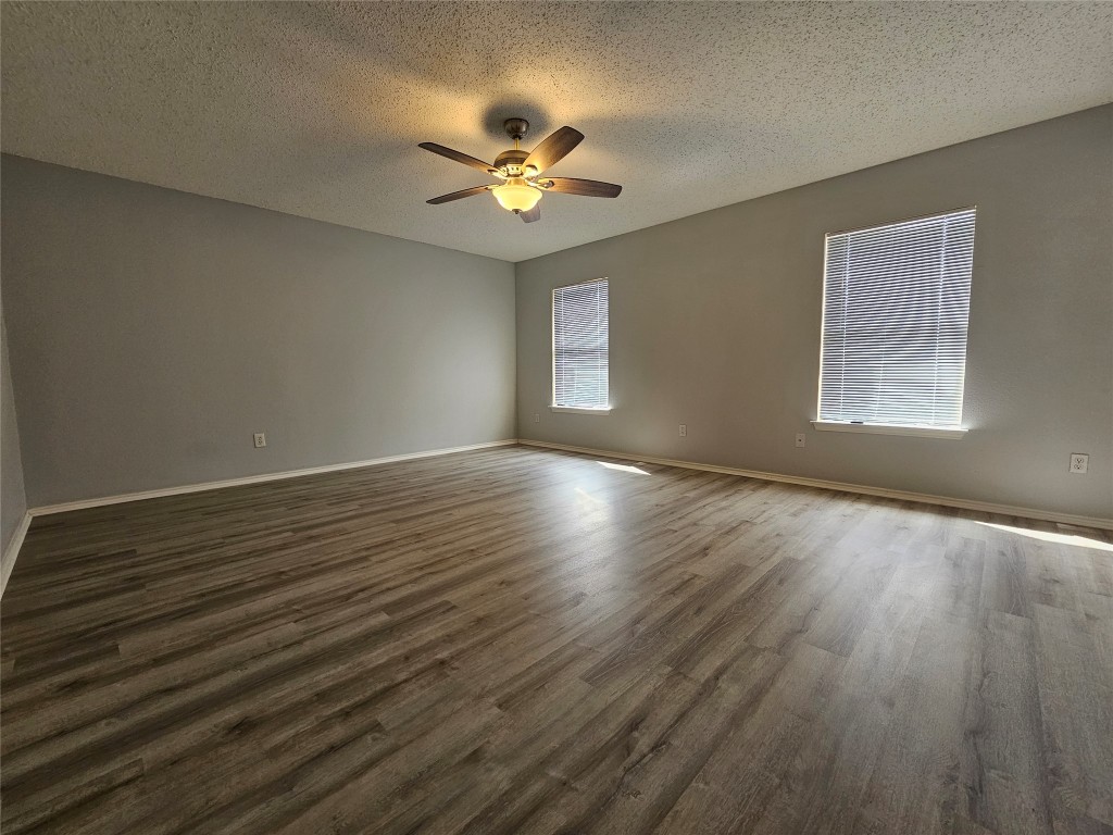 1113 Stillwell Ridge Cedar Park, TX 78613 - Photo 13 of 32 a view of an empty room with wooden floor and a window