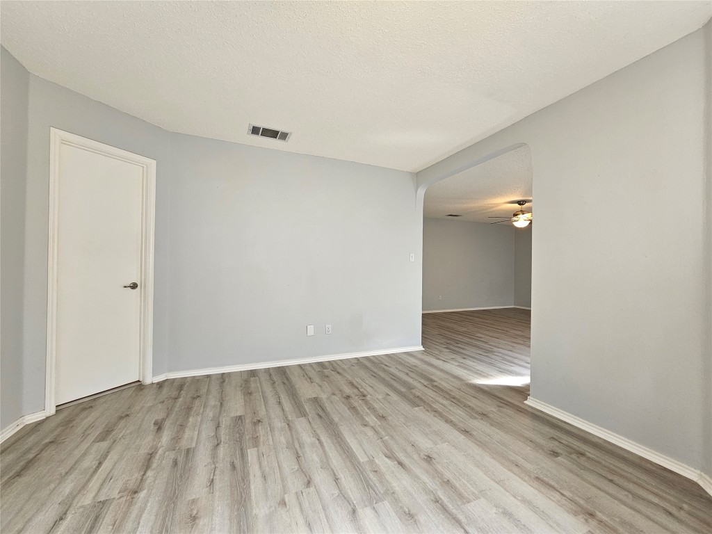 1113 Stillwell Ridge Cedar Park, TX 78613 - Photo 17 of 32 a view of an empty room with wooden floor and a window