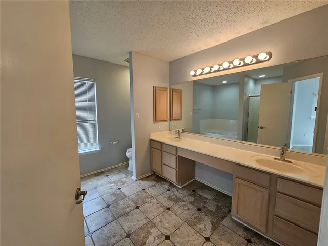 a bathroom with a sink a vanity and a mirror