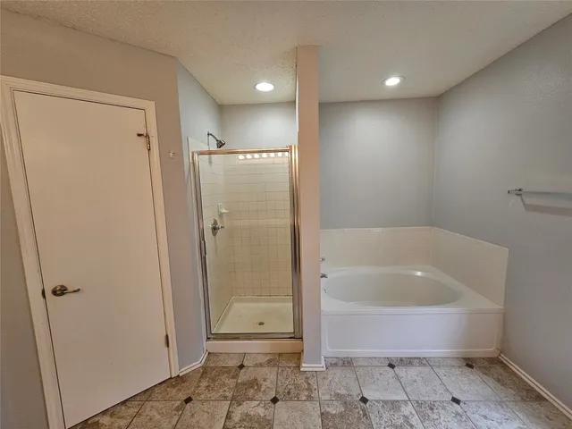 a bathroom with a bathtub and a shower