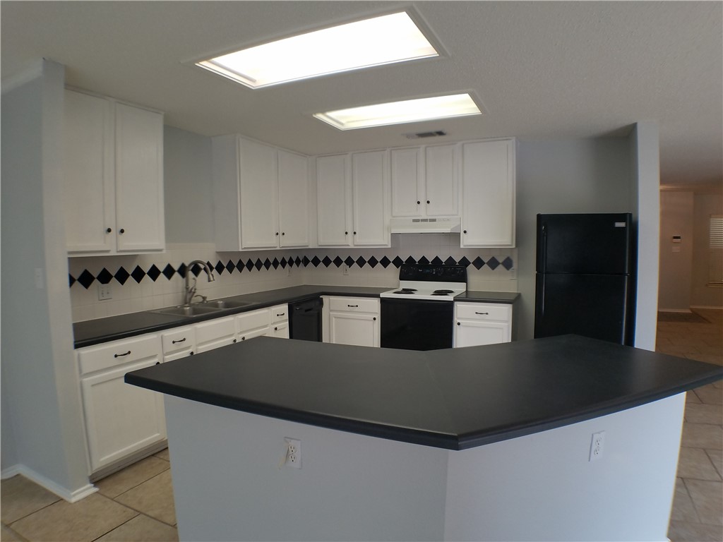 1113 Stillwell Ridge Cedar Park, TX 78613 - Photo 6 of 32 a kitchen with a sink a stove and refrigerator