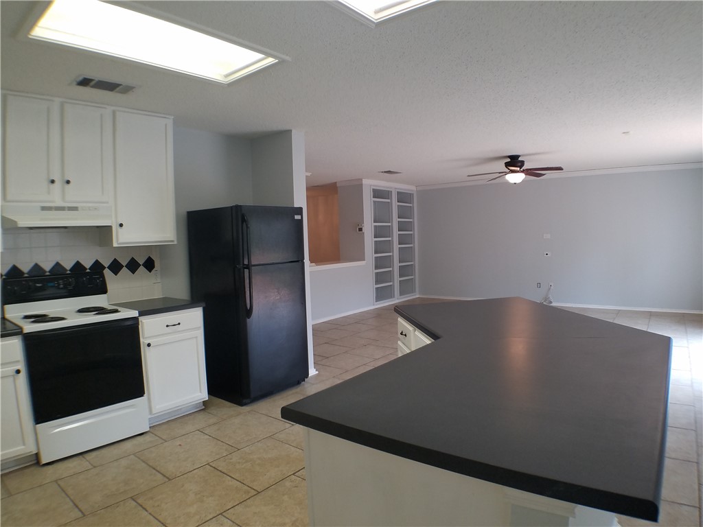 1113 Stillwell Ridge Cedar Park, TX 78613 - Photo 7 of 32 a view of a kitchen with a stove top oven and cabinets