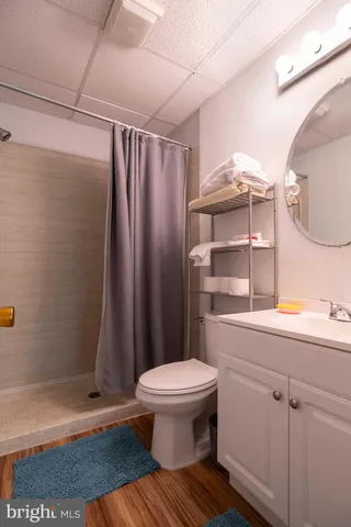 a living room with kitchen island furniture and a chandelier