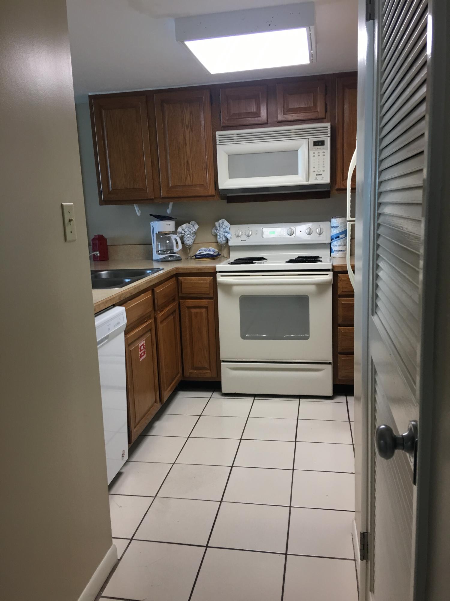 4100 East County Highway 30A, Unit 204 Santa Rosa Beach, FL 32459 - Photo 5 of 27 a kitchen with a stove cabinets and a sink