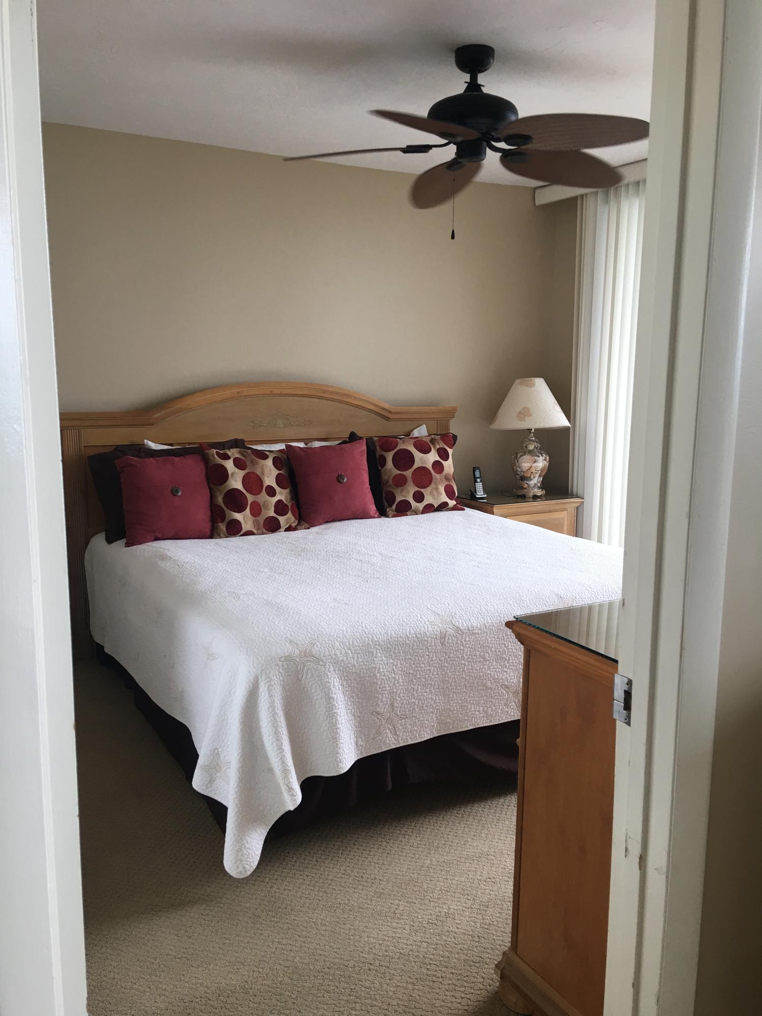 4100 East County Highway 30A, Unit 204 Santa Rosa Beach, FL 32459 - Photo 7 of 27 a bedroom with a bed and a chandelier