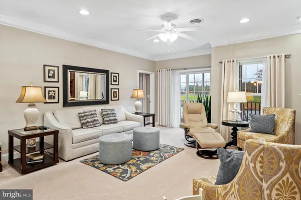 a view of a bedroom with cabinet flat screen tv and windows