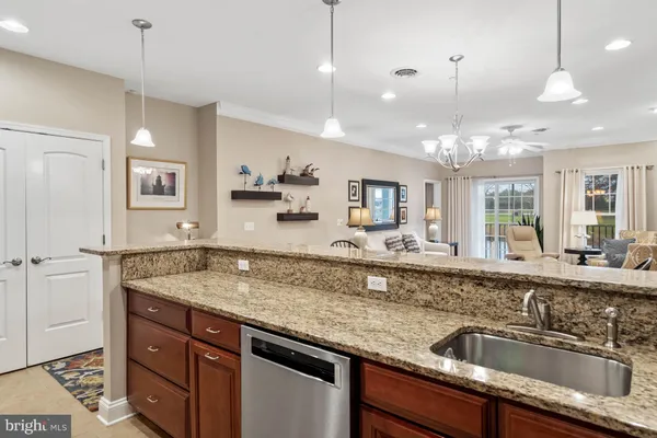 a kitchen with granite countertop wood cabinets and a stove top oven