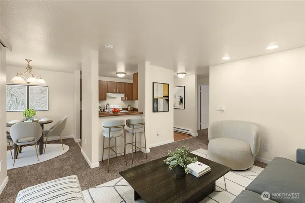 a living room with furniture and view of kitchen
