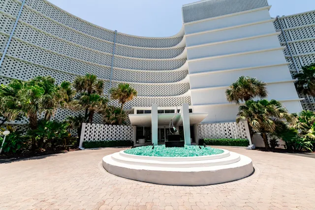 an aerial view of a house with a garden and lake view