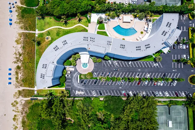 a view of a backyard with chair and flower plants