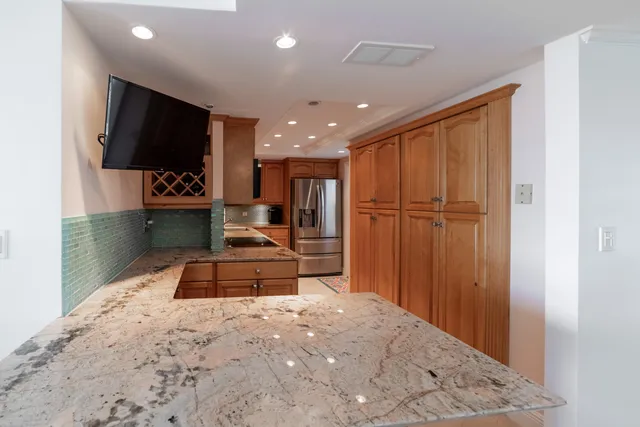 a large bedroom with a bed and a flat screen tv