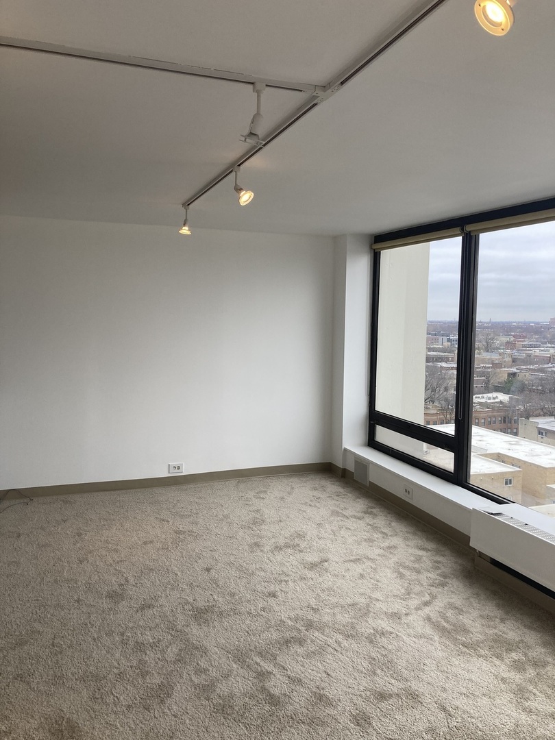 5445 North Sheridan Road, Unit 1409 Chicago, IL 60640 - Photo 4 of 7 a view of an empty room with a window