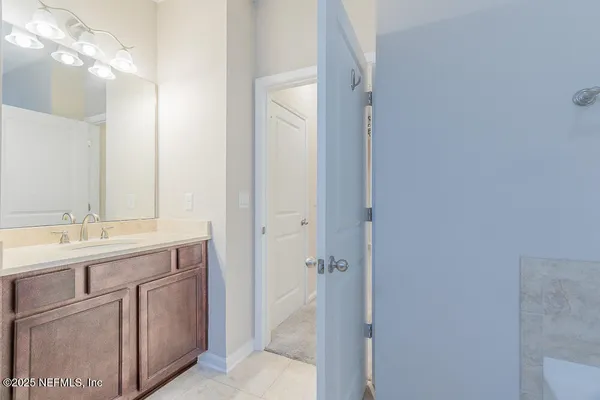 a bathroom with a granite countertop sink two mirror and a