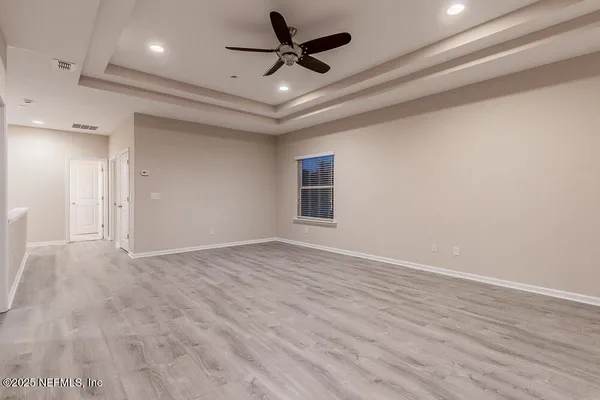 a view of an empty room with a ceiling fan