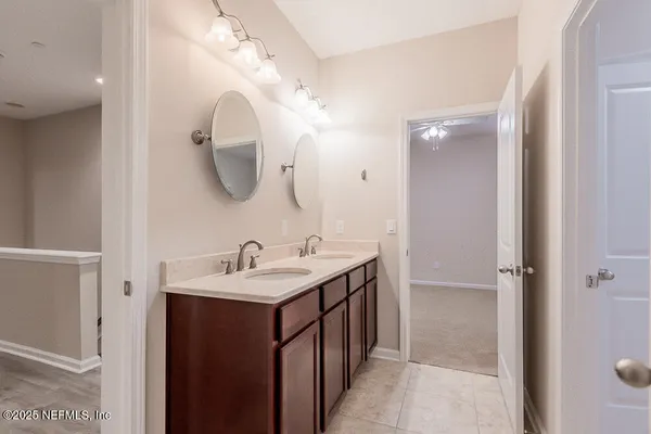 a bathroom with a tub a sink and a mirror