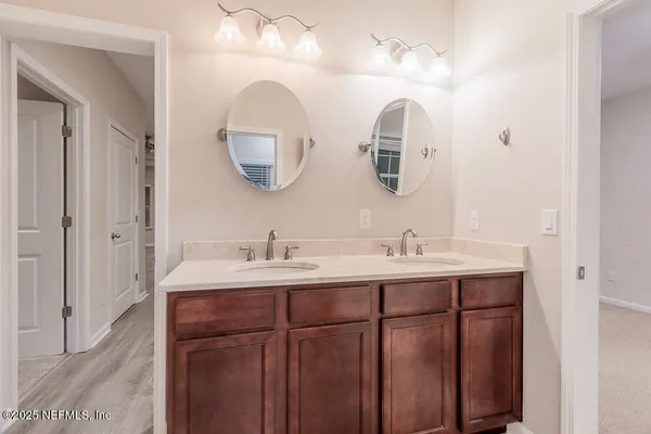 a bathroom with a double vanity sink and a mirror