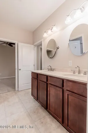 a bathroom with a sink a vanity and a mirror