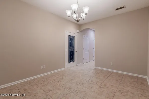 a view of a chandelier in big room and chandelier