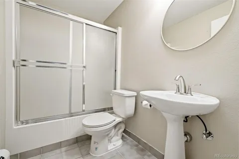 a bathroom with a toilet a sink and a mirror