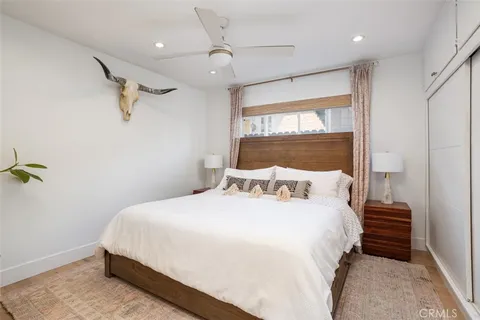 a bedroom with a bed and a large window