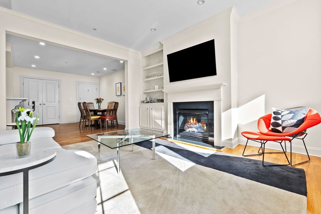 33 Intrepid Circle, Unit 208 Marblehead, MA 01945 - Photo 12 of 35 a living room with furniture a fireplace and a flat screen tv