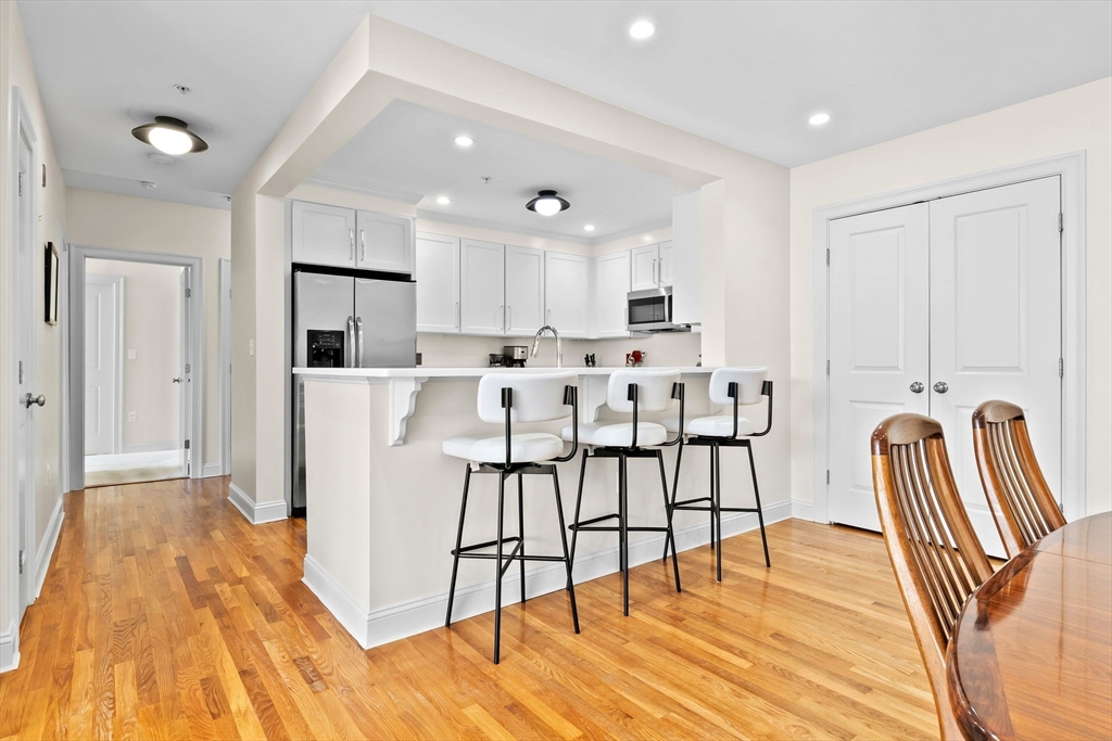 33 Intrepid Circle, Unit 208 Marblehead, MA 01945 - Photo 15 of 35 a view of kitchen with cabinets and wooden floor