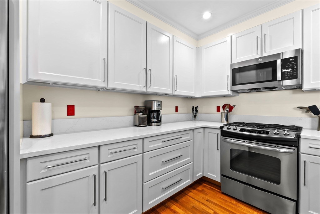 33 Intrepid Circle, Unit 208 Marblehead, MA 01945 - Photo 17 of 35 a kitchen with white cabinets and stainless steel appliances