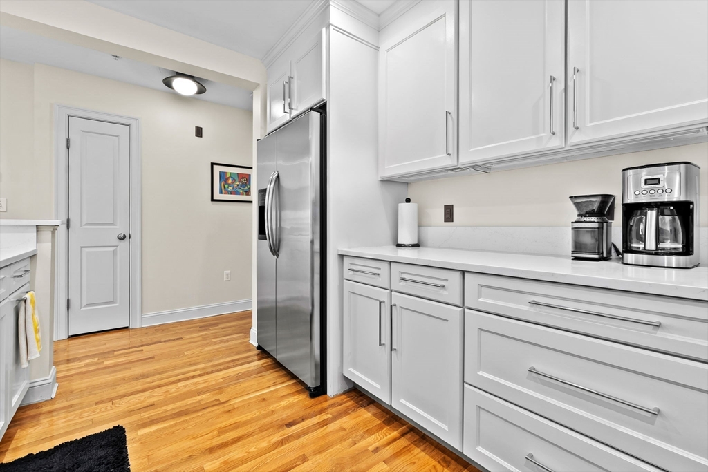 33 Intrepid Circle, Unit 208 Marblehead, MA 01945 - Photo 18 of 35 a kitchen with white cabinets and refrigerator