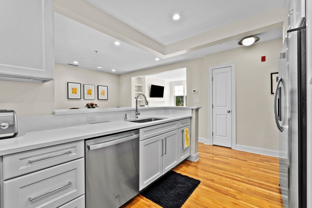 33 Intrepid Circle, Unit 208 Marblehead, MA 01945 - Photo 19 of 35 a kitchen with stainless steel appliances granite countertop a sink stove and refrigerator