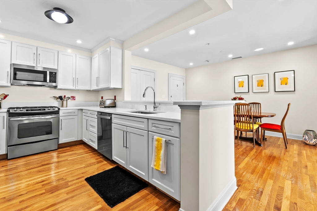 33 Intrepid Circle, Unit 208 Marblehead, MA 01945 - Photo 20 of 35 a kitchen with stainless steel appliances kitchen island granite countertop a refrigerator and a stove top oven