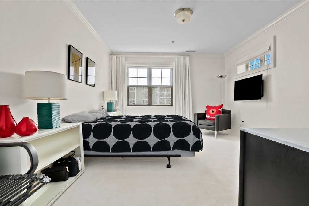 33 Intrepid Circle, Unit 208 Marblehead, MA 01945 - Photo 21 of 35 a bedroom with furniture and a flat screen tv