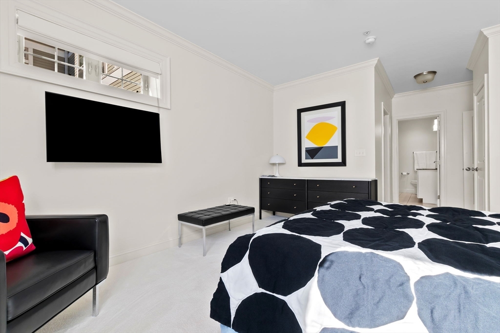 33 Intrepid Circle, Unit 208 Marblehead, MA 01945 - Photo 22 of 35 a bedroom with a bed and a flat screen tv