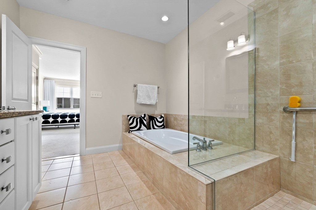 33 Intrepid Circle, Unit 208 Marblehead, MA 01945 - Photo 26 of 35 a bathroom with a tub sink and mirror