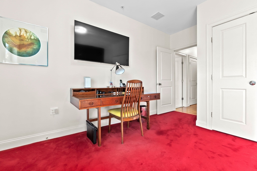 33 Intrepid Circle, Unit 208 Marblehead, MA 01945 - Photo 29 of 35 a view of a livingroom with furniture and a flat screen tv