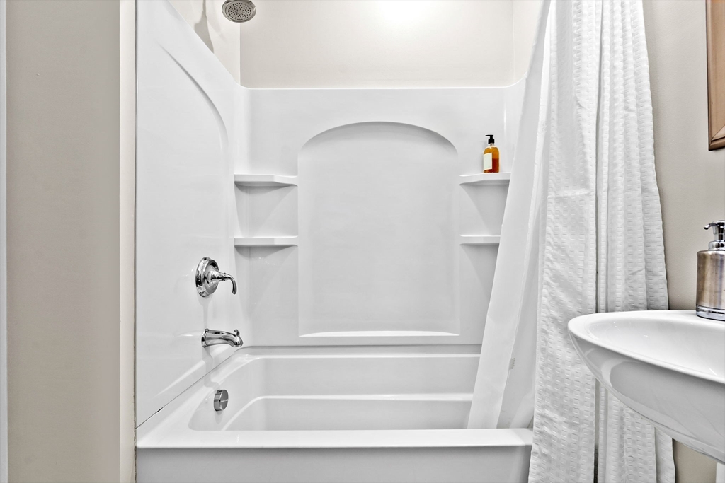 33 Intrepid Circle, Unit 208 Marblehead, MA 01945 - Photo 31 of 35 a bathroom with a bathtub and a shower