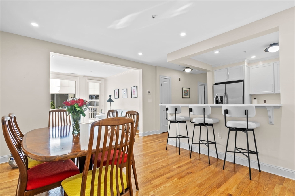 33 Intrepid Circle, Unit 208 Marblehead, MA 01945 - Photo 4 of 35 a view of a dining room with furniture and wooden floor