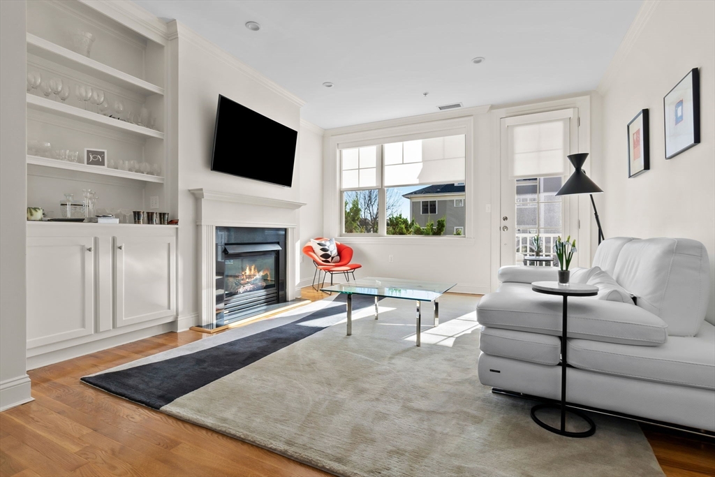 33 Intrepid Circle, Unit 208 Marblehead, MA 01945 - Photo 10 of 35 a living room with furniture a flat screen tv and a fireplace