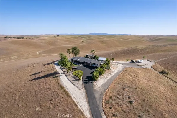 an aerial view of a house with a ocean view