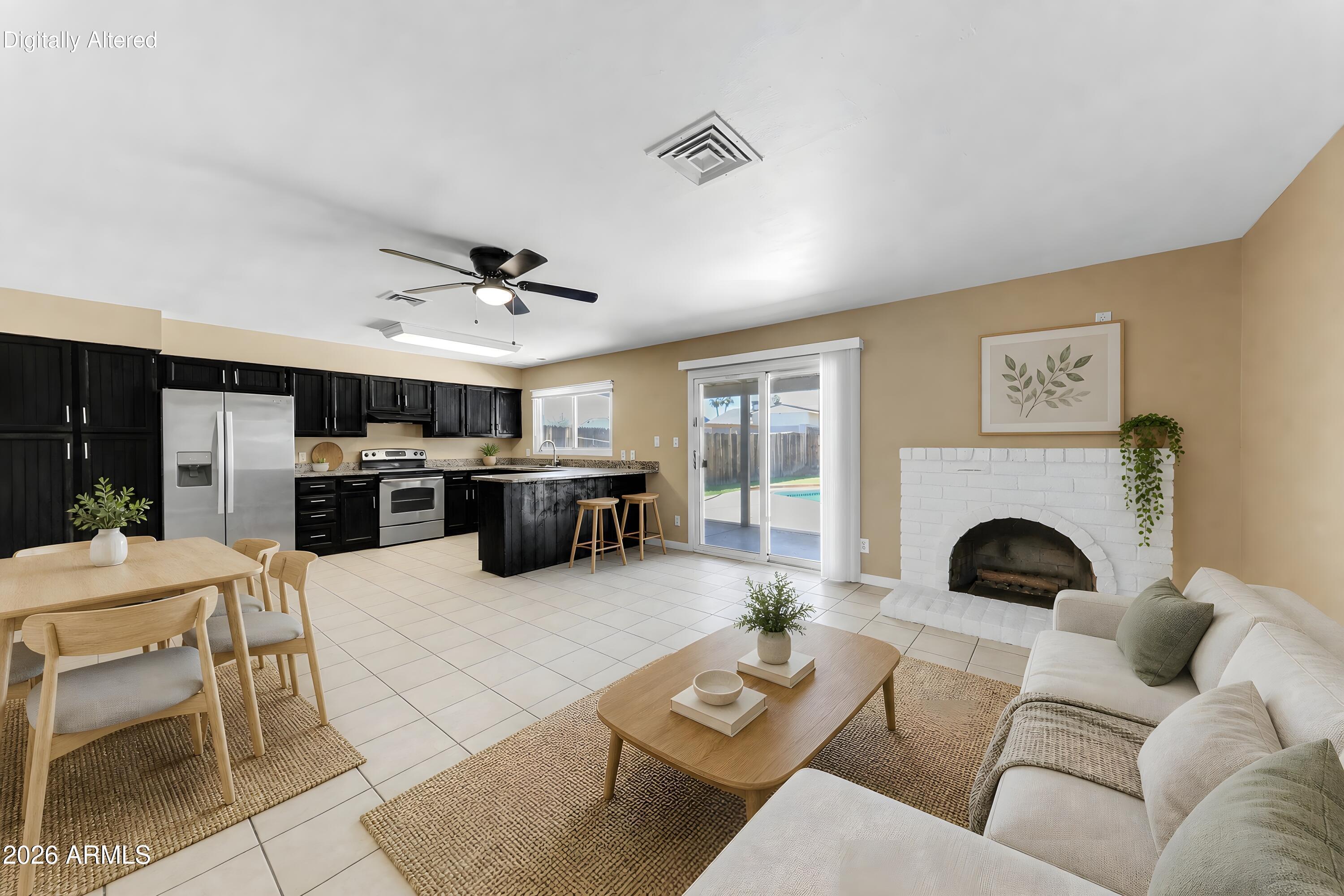 4723 East Vineyard Road Phoenix, AZ 85042 - Photo 6 of 27 a living room with furniture and a fireplace