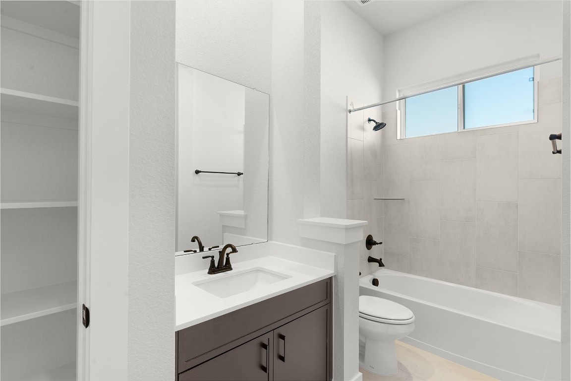 101 Golden Sage Avenue Georgetown, TX 78633 - Photo 11 of 24 a bathroom with a sink a toilet and shower