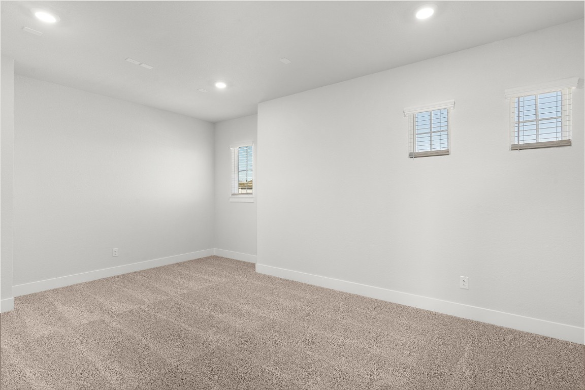 101 Golden Sage Avenue Georgetown, TX 78633 - Photo 13 of 24 Empty room featuring carpet floors and recessed lighting
