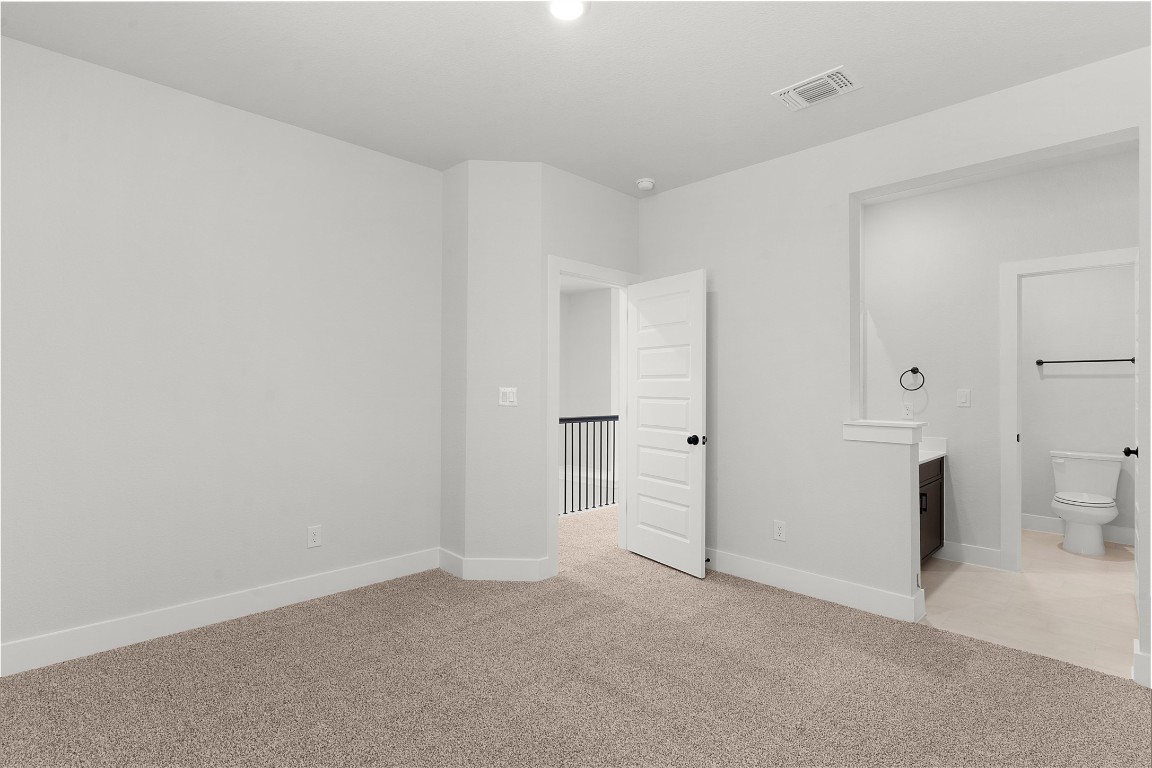101 Golden Sage Avenue Georgetown, TX 78633 - Photo 15 of 24 Unfurnished bedroom with light carpet and baseboards