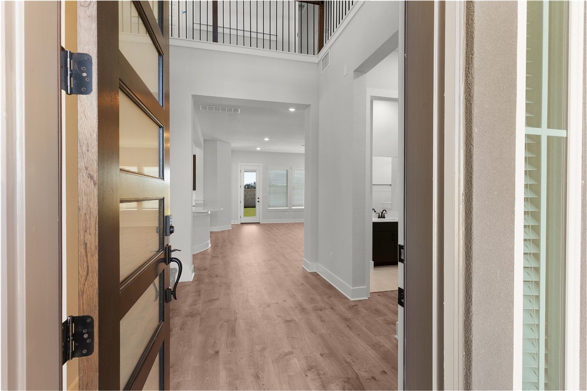 101 Golden Sage Avenue Georgetown, TX 78633 - Photo 2 of 24 Entryway with light wood-style flooring, a towering ceiling, and recessed lighting